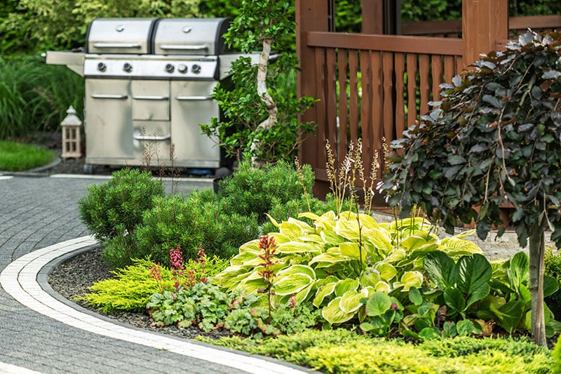 Landscaped backyard with grill area